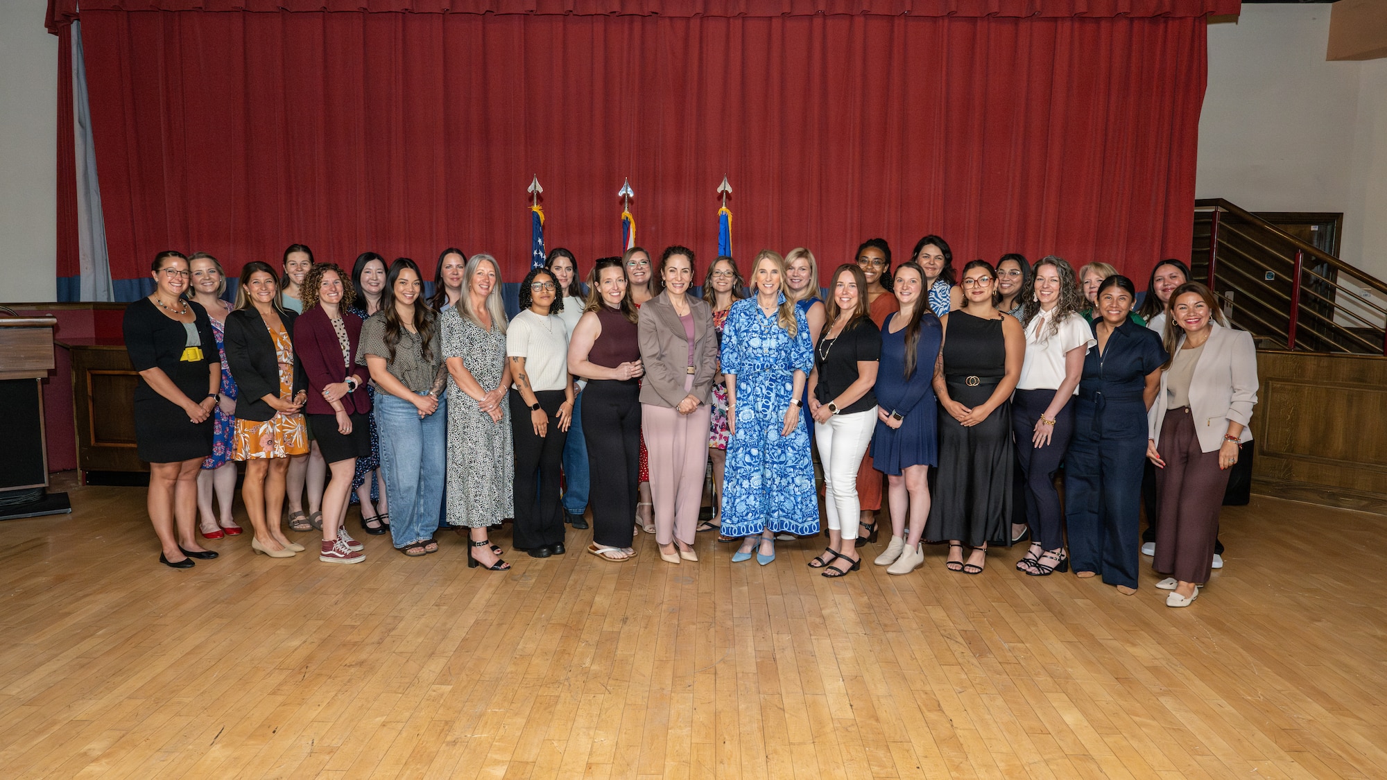 Team Mildenhall key support liaisons and senior leader wives pose for a group photo during a senior leader spouse engagement at RAF Mildenhall, England, July 13, 2026.