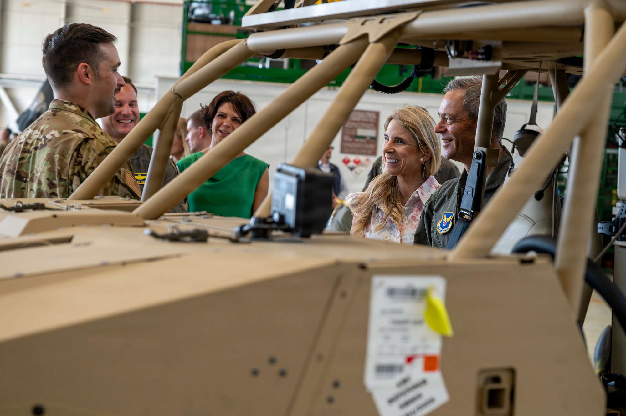 A man and woman view a tactical vehicle used for firefighting.