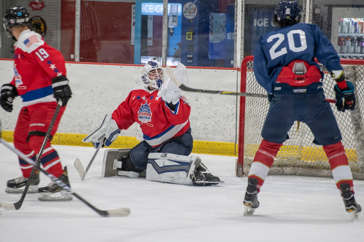 U.S. Air Force 1st Lt. Stanislav V. Barilov, 316th Security Forces Group executive officer, reaches to make a save for the D.C. Armed Forces Hockey Club during a game at Piney Orchard Ice Arena in Odenton, Maryland, June 27, 2026.