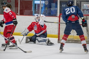 U.S. Air Force 1st Lt. Stanislav V. Barilov, 316th Security Forces Group executive officer, reaches to make a save for the D.C. Armed Forces Hockey Club during a game at Piney Orchard Ice Arena in Odenton, Maryland, June 27, 2026.