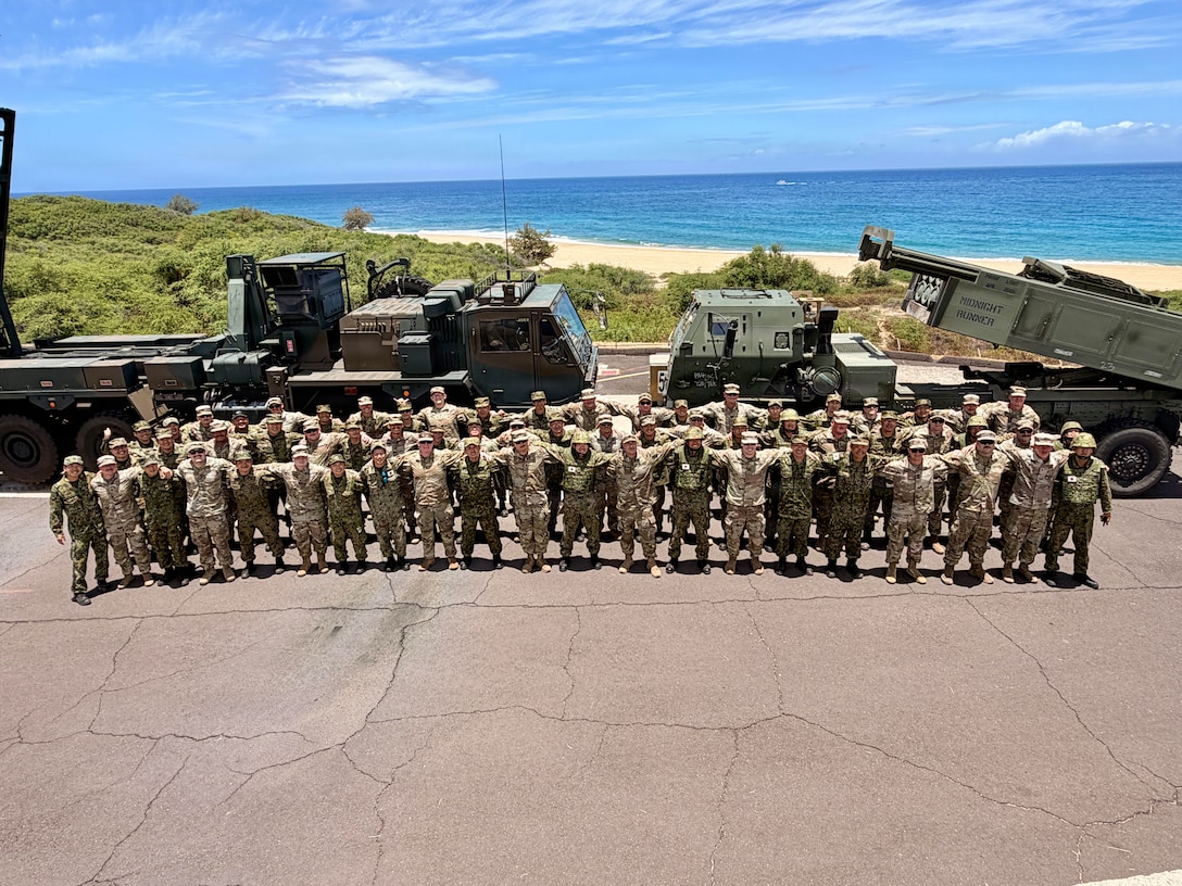 Kentucky National Guardsmen with the 1st Battalion, 623rd Field Artillery Regiment gather with members of the Japanese Ground Self Defense Force after the final rounds were fired of a combined live-fire exercise during Exercise Rim of the Pacific 2026 in Pacific Missile Range Facility Barking Sands in Kauai, Hawaii, July 12, 2026.