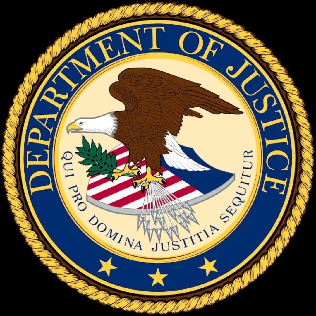 Department of Justice seal with an eagle standing on top of a shield with red and white stripes, 3 gold stars.