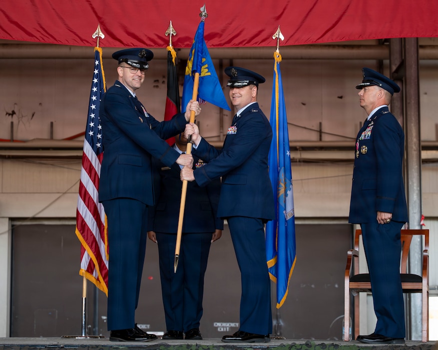 men pose for a photo during a ceremony