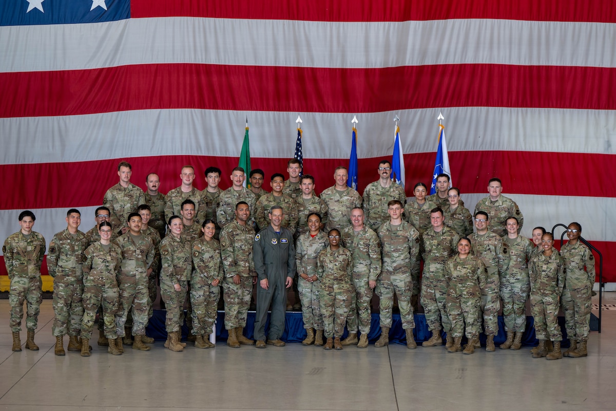 A large group stands together for a photo.