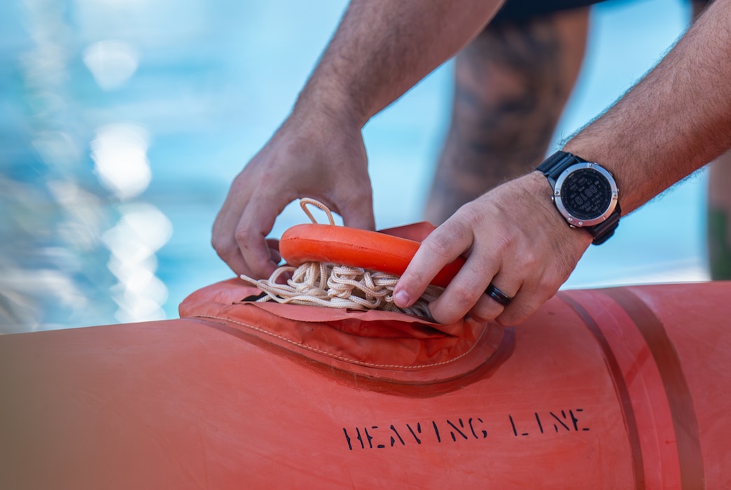 U.S. Air Force Master Sgt. Travis Heard, 507th Operations Support Squadron survival, evasion, resistance, and escape (SERE) specialist demonstrates how the Heaving Line is utilized in Water Survival Training at Altus Air Force Base, Oklahoma, July 10, 2026. Prior to conducting the hands-on training, SERE specialists demonstrated how to properly use emergency survival gear. (U.S. Air Force photo by Airman 1st Class Emma Wright)