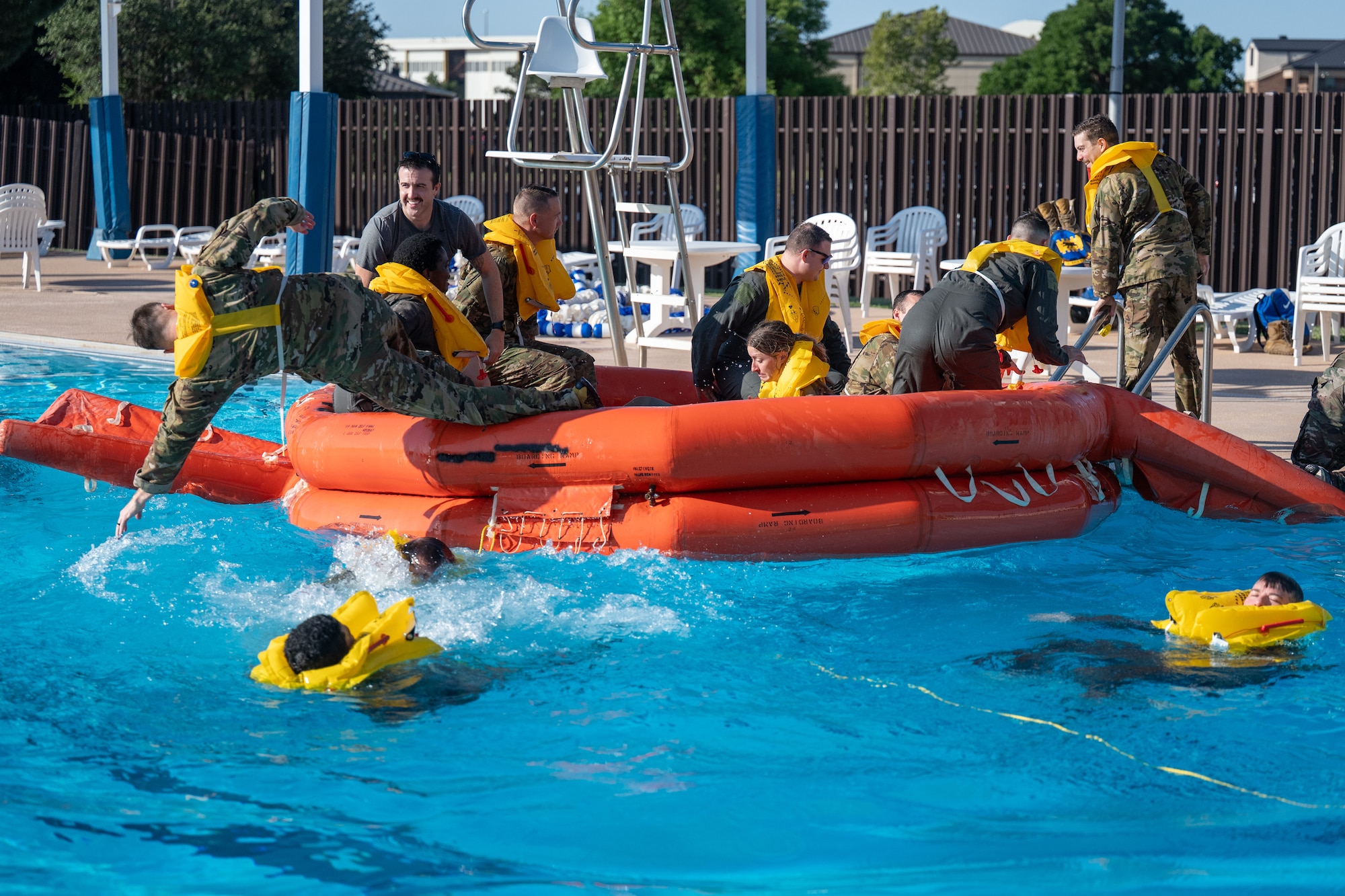 U.S. Air Force Airmen assigned to Altus Air Force Base (AFB) jump out of a life raft during Water Survival Training at Altus AFB, Oklahoma, July 10, 2026. All U.S. Air Force aircrew must complete Water Survival Training every three years to maintain currency. (U.S. Air Force photo by Airman 1st Class Emma Wright)