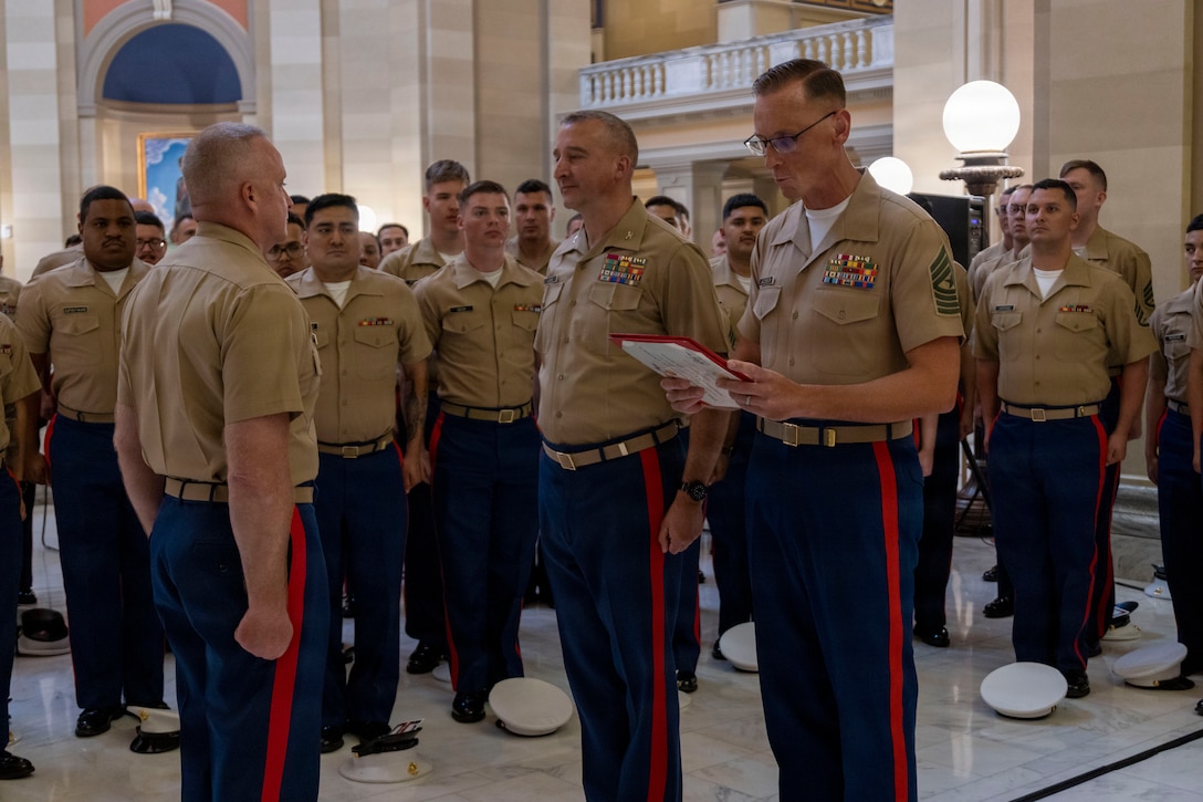 U.S. Marine Corps Col. Aaron Lloyd, center, the commanding officer of 9th Marine Corps District, and Sgt. Maj. Daniel Jacobson, right, Recruiting Station Oklahoma City senior enlisted leader, awards Maj. Darryl Gravelle following a change of command ceremony at the Oklahoma State Capitol in Oklahoma City, Oklahoma, July 1, 2026. A change of command ceremony is a Marine Corps tradition that formally transfers responsibility, authority, and accountability from one commanding officer to another. (U.S. Marine Corps photo by Staff Sgt. Lennon Dregoiw)