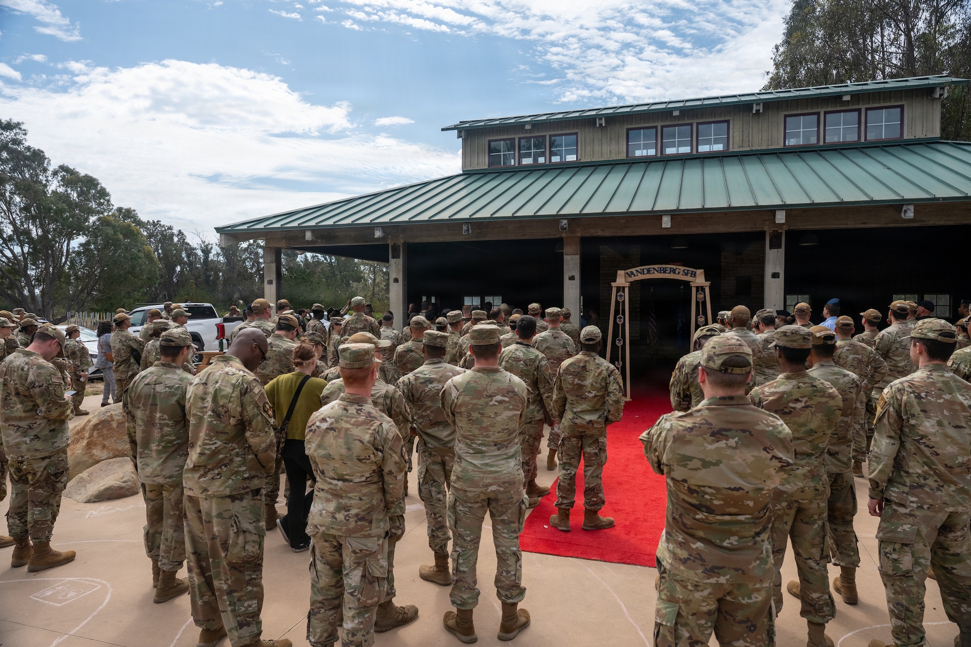 People gather outside a pavilion.