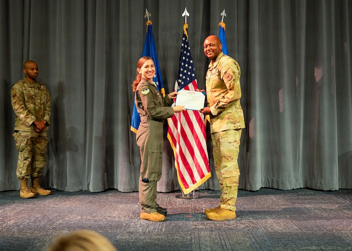 U.S. Air Force Col. Ellen Canup, Curtis E. LeMay Center commander, presents the Legion of Merit to Col. Damian Holtzclaw, the outgoing commander of Air Force Global College, during a change of command ceremony at Maxwell Air Force Base, Ala., July 10, 2026.