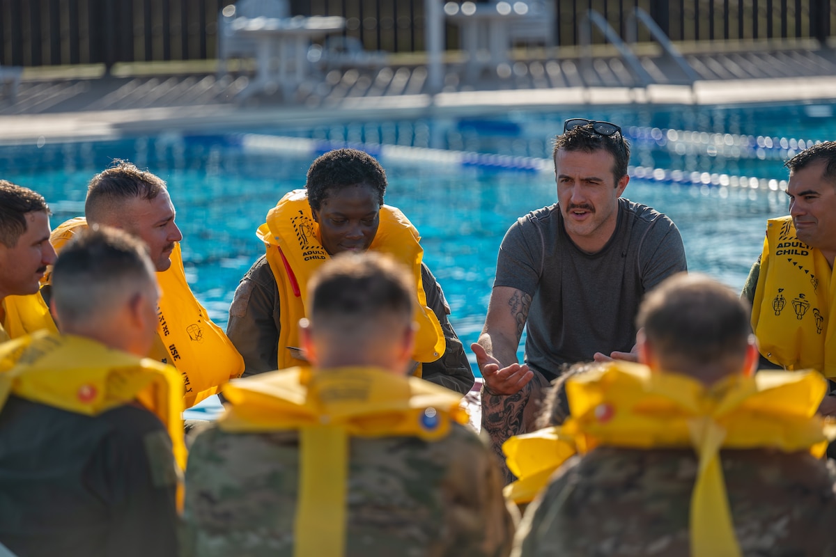 U.S. Air Force Master Sgt. Russel Batson, 137th Special Operations Support Squadron survival, evasion, resistance, and escape (SERE) specialist, leads aircrew assigned to Altus Air Force Base (AFB) through Water Survival Training at Altus AFB, Oklahoma, July 10, 2026. The refresher training combined academic instruction with hands-on exercises designed to sharpen wartime operational skills. (U.S. Air Force photo by Airman 1st Class Emma Wright)