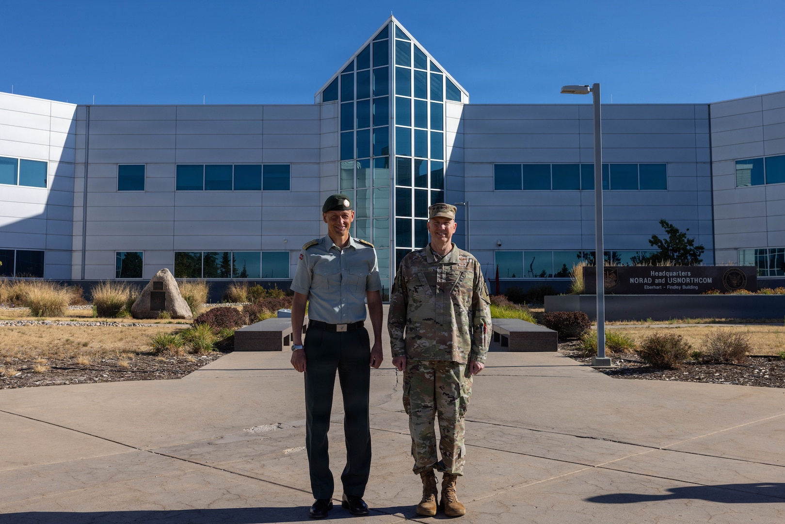 General Gregory Guillot, commander, North American Aerospace Defense Command and U.S. Northern Command and General Eirik Kristoffersen, Norwegian Chief of Defence, stand for a photo in front of the command’s headquarters building in Colorado Springs, Colorado, July 14, 2026. General Kristoffersen visited NORAD and USNORTHCOM to discuss opportunities for arctic and High North collaboration.  (U.S. Department of War photo by MSgt Tabitha M. Lee)