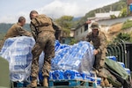Marines prepare to offload cases of water from the back of a truck for disaster assistance operations in Anare, Venezuela, July 8, 2026.