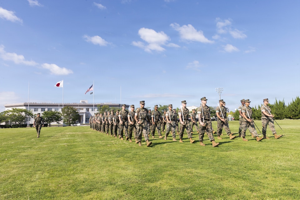U.S. Marines attending the Marine Corps Air Station Iwakuni Sergeants Course practice drill and ceremony at MCAS Iwakuni, Yamaguchi, Japan, July 9, 2026. The inaugural resident sergeants course expanded professional military education opportunities for Marines stationed in Japan. (U.S. Marine Corps photo by Staff Sgt. Julian Elliott-Drouin)