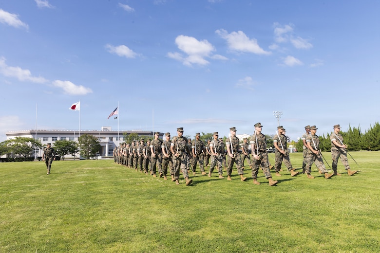 U.S. Marines attending the Marine Corps Air Station Iwakuni Sergeants Course practice drill and ceremony at MCAS Iwakuni, Yamaguchi, Japan, July 9, 2026. The inaugural resident sergeants course expanded professional military education opportunities for Marines stationed in Japan. (U.S. Marine Corps photo by Staff Sgt. Julian Elliott-Drouin)