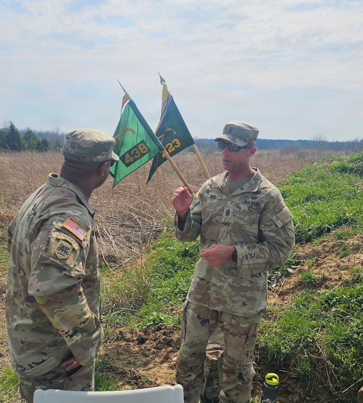 Command Sgt. Maj. Tomothy Nein talks with 1st Sgt. Clifford Marbrey during a field training exercise.
