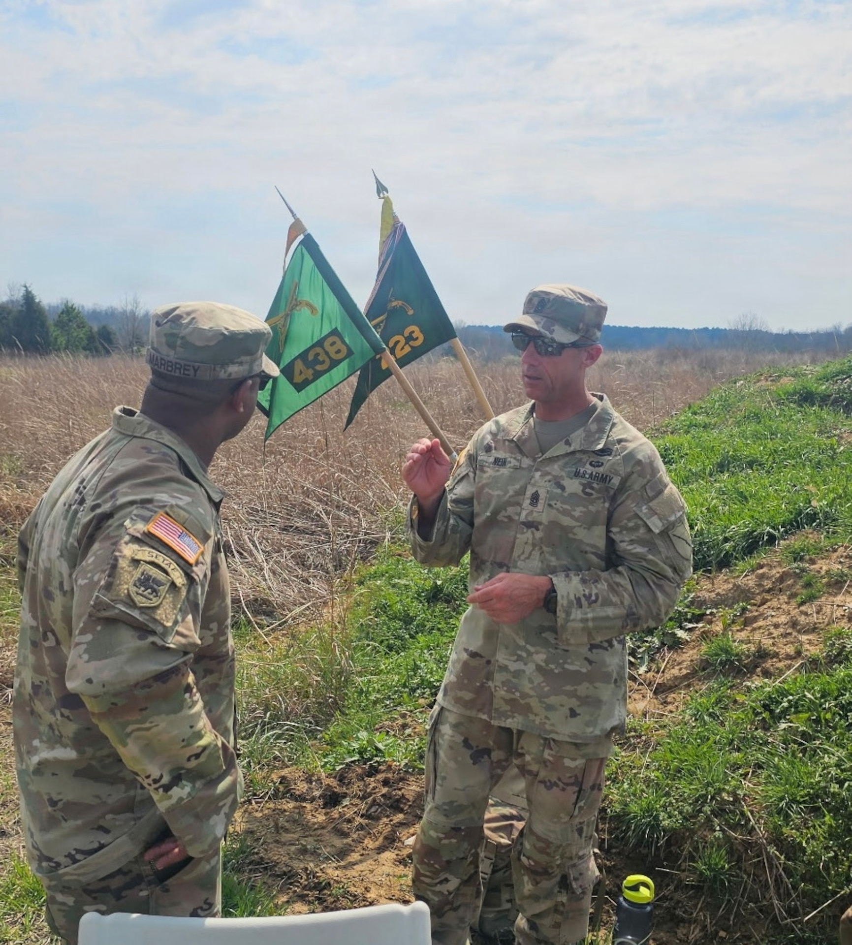 Command Sgt. Maj. Tomothy Nein talks with 1st Sgt. Clifford Marbrey during a field training exercise.