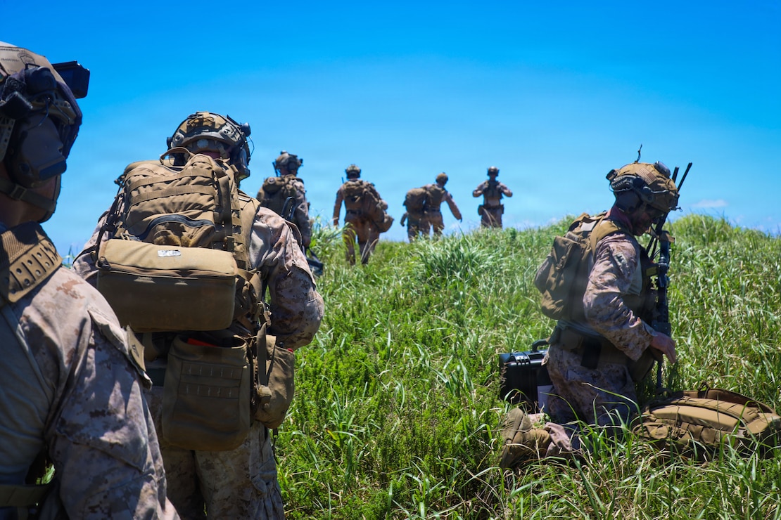 U.S. Marines with 3rd Battalion, 7th Marine Regiment, 1st Marine Division currently forward deployed with 4th Marine Regiment, 3rd Marine Division as part of the Unit Deployment Program, prepare to dismount establish an observation post prior to a close air support range on Camp Schwab, Okinawa, Japan, July 8, 2026. The range was conducted to improve the Marines' tactical proficiency while conducting CAS maneuvers. (U.S. Marine Corps photo by Staff Sgt. Trey Q. Michael)