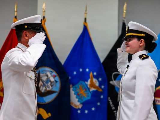 (260710-N-AJ782-1171) FALLS CHURCH, Va. From right to left, U.S. Navy Ensign Jenna Hosea Baker, a nurse assigned to Walter Reed National Military Medical Center, receives her first salute from Senior Chief Petty Officer Roberto C. Songco, Naval Support Activity Bethesda senior enlisted leader, as part of a joint ceremony featuring the retirement of her father at Defense Health Headquarters in Falls Church, Virginia, July 10, 2026. The retirement of Capt. Lonnie S. Hosea, Bureau of Medicine and Surgery senior health policy advisor, and the commissioning of Baker highlighted a continuing legacy of service for Navy Medicine as Hosea closed out a 30-year career and Baker took her first steps into the Nurse Corps. (U.S. Navy photo by Kevin Ray J. Salvador)