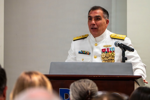 (260710-N-AJ782-1239) FALLS CHURCH, Va. U.S. Navy Rear Adm. Matthew Case, acting Surgeon General of the Navy and acting chief, U.S. Navy Bureau of Medicine and Surgery (BUMED), delivers remarks as part of a joint ceremony featuring the retirement of Capt. Lonnie S. Hosea, Bureau of Medicine and Surgery senior health policy advisor, and the commissioning of Ensign Jenna Hosea Baker, a nurse assigned to Walter Reed National Military Medical Center, at Defense Health Headquarters in Falls Church, Virginia, July 10, 2026. The ceremony highlighted a continuing legacy of service for Navy Medicine as Hosea closed out a 30-year career and Baker took her first steps into the Nurse Corps. (U.S. Navy photo by Kevin Ray J. Salvador)