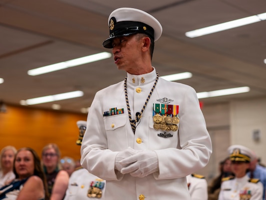 (260710-N-AJ782-1569) FALLS CHURCH, Va. U.S. Navy Senior Chief Petty Officer Roberto C. Songco, Naval Support Activity Bethesda senior enlisted leader, recites “The Watch” as part of a joint ceremony featuring the retirement of Capt. Lonnie S. Hosea, Bureau of Medicine and Surgery senior health policy advisor, and the commissioning of Ensign Jenna Hosea Baker, a nurse assigned to Walter Reed National Military Medical Center, at Defense Health Headquarters in Falls Church, Virginia, July 10, 2026. The ceremony highlighted a continuing legacy of service for Navy Medicine as Hosea closed out a 30-year career and Baker took her first steps into the Nurse Corps. (U.S. Navy photo by Kevin Ray J. Salvador)