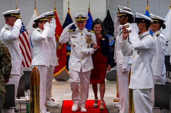 (260710-N-AJ782-1622) FALLS CHURCH, Va. From left to right, U.S. Navy Capt. Lonnie S. Hosea, U.S. Navy Bureau of Medicine and Surgery senior health policy advisor, is piped ashore alongside his wife, Deanna McAlister Hosea, during a joint retirement and commissioning ceremony at Defense Health Headquarters in Falls Church, Virginia, July 10, 2026. Hosea and his daughter, Ensign Jenna Hosea Baker, who is a nurse assigned to Walter Reed National Military Medical Center, highlighted a continuing legacy of service for Navy Medicine as Hosea closed out a 30-year career and Baker took her first steps into the Nurse Corps. (U.S. Navy photo by Kevin Ray J. Salvador)
