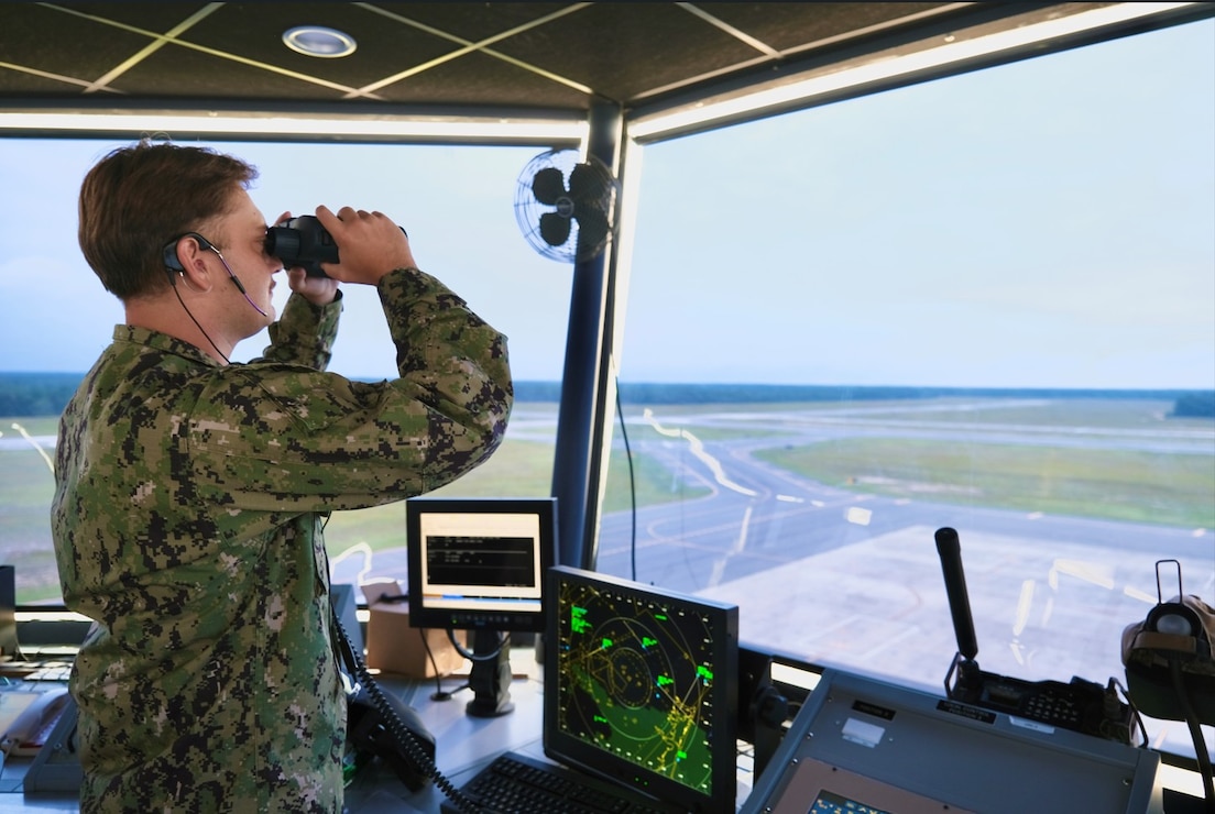 An Air Traffic Controller assigned to NSA Lakehurst observes airfield operations from the tower at Lakehurst Maxfield Field.