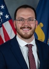 Kyle Risher poses for an official portrait at Naval Surface Warfare Center, Carderock Division in West Bethesda, Md. Risher serves as an operations research analyst in Carderock's Military Effectiveness Group and is a member of the joint Energy Supportability Analysis team recognized with the 2026 Warfare Center Innovation Award.