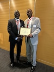 U.S. Naval Research Laboratory (NRL) NRL Center for Biomolecular Science and Engineering Research Chemist Paul Charles (left) supports NRL Chemist Darryl Boyd, Ph.D., (right) who received the Washington Academy of Sciences Krupshaw Award for Non-Traditional Teaching during an awards ceremony held at the Center for Naval Analysis in Arlington, Virginia, May 7, 2026, for his extensive and comprehensive efforts as a science teacher, mentor and Science, Technology, Engineering, and Math (STEM) advocate in the Washington, D.C., metro area. (U.S. Navy photo)