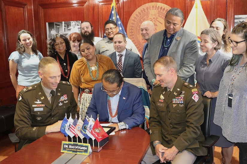 Navajo Nation President Buu Nygren, center, and U.S. Army Corps of Engineers Los Angeles District Commander Col. Andrew Baker, center left, sign an agreement for a $3 million feasibility study for the Birdsprings Flood-Risk Mitigation project June 1 in Window Rock, Arizona