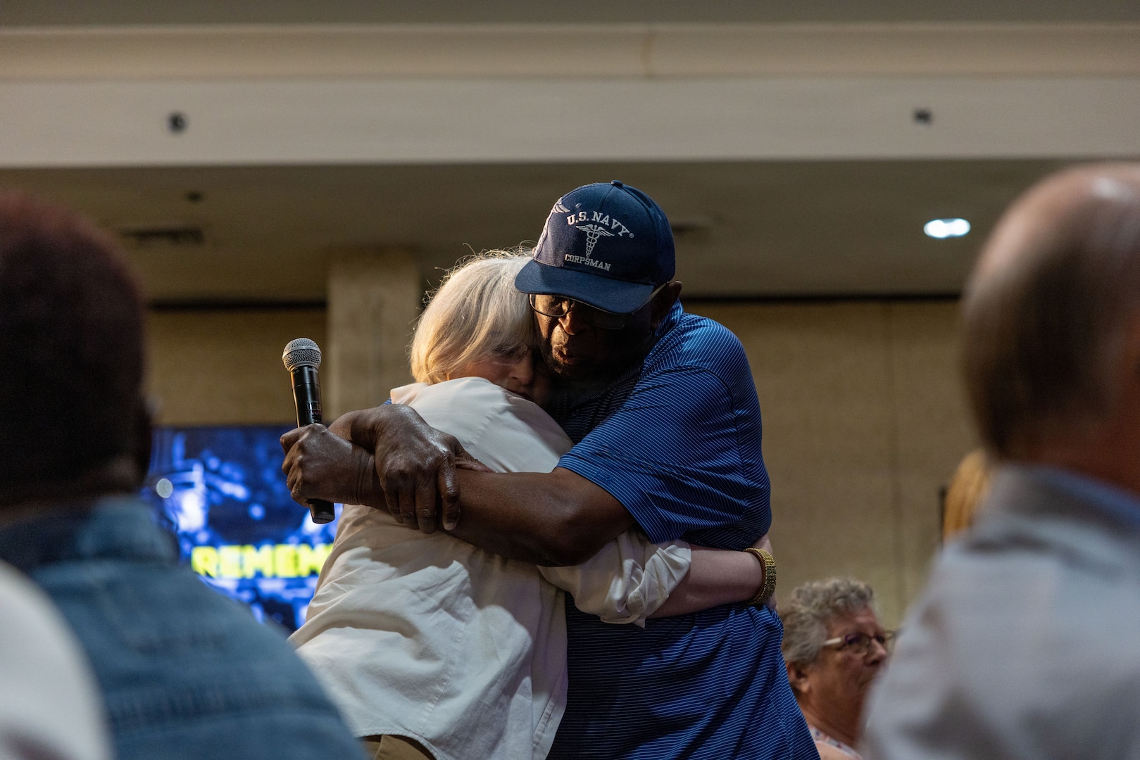 Jeff J. Williams, next of kin to U.S. Marine Corps Capt. Larry Potts, and Lorin Walker, next of kin to U.S. Air Force Capt. Bruce Walker, embrace each other during the 2026 Vietnam War Annual Government Briefing in Arlington, Virginia