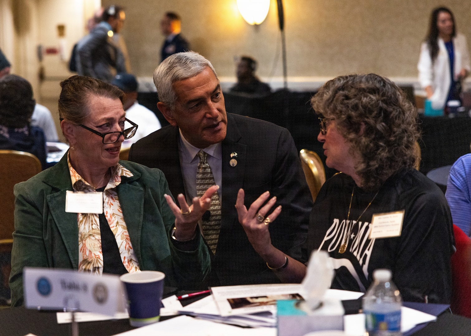 elly McKeague, Defense POW/MIA Accounting Agency director, center, speaks with Mrs. Linda Sax, left, and Mrs. Luanne Stofel, right, Gold Star family members, on day two of the Vietnam Annual Government Briefing