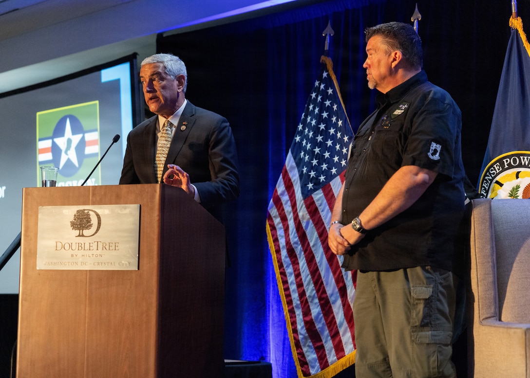 Kelly McKeague, Defense POW/MIA Accounting Agency director, left, speaks at the Vietnam Annual Government Briefing alongside Dave Huffman, Norfolk International Airport chief of police.