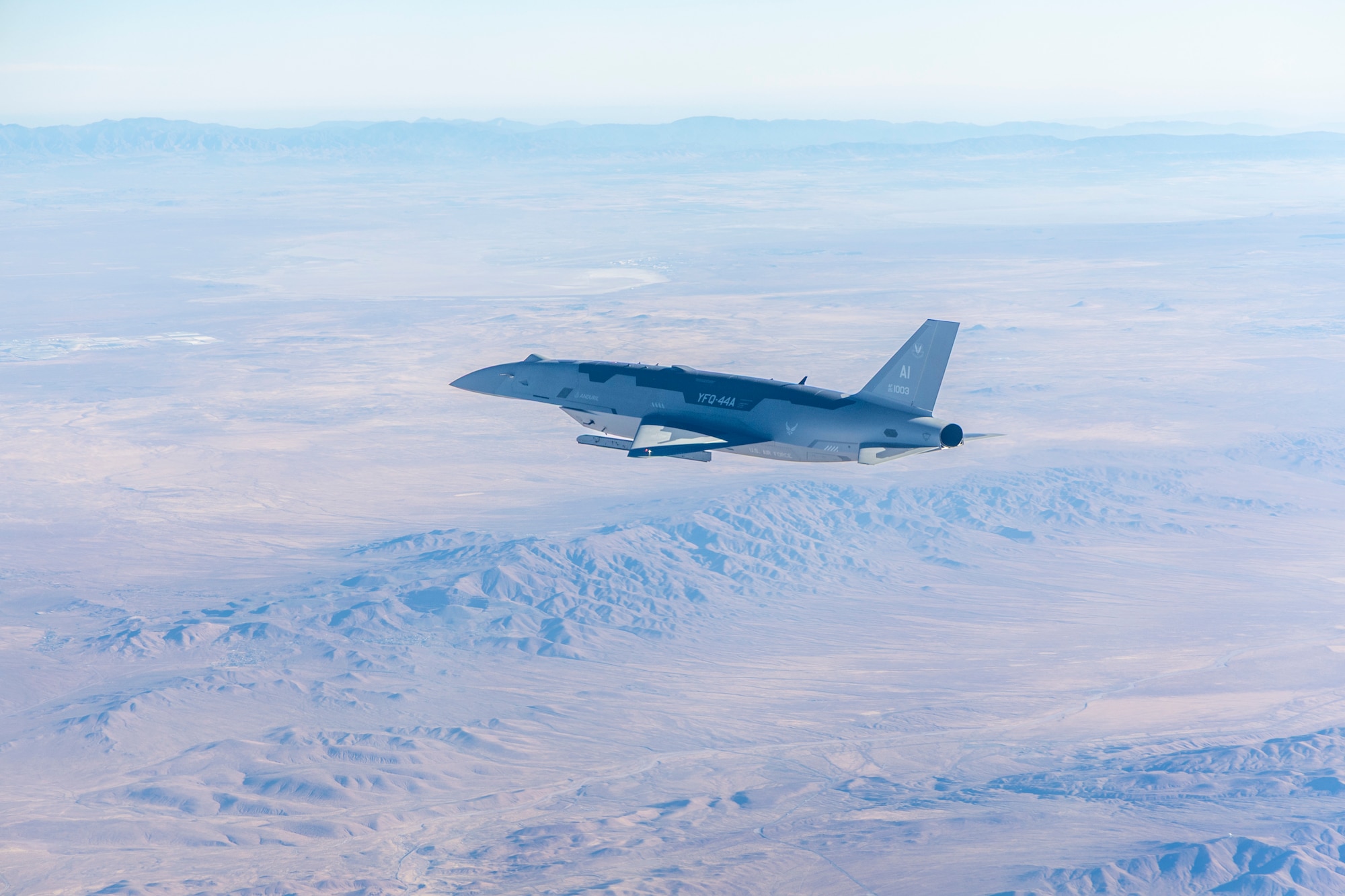A YFQ-44A Collaborative Combat Aircraft flies over the Mojave Desert after conducting live-fire testing over the Mojave Desert.