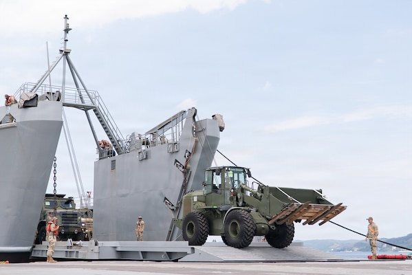 A military 624K wheel loader offloads from a Logistics Support Vessel onto Trident Pier during CJLOTS operations in Pohang, South Korea.