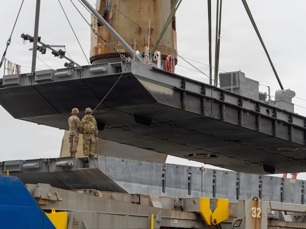 A crane aboard the Ocean Giant vessel lifts a Modular Warping Tug into the water at Pohang Port, South Korea, during CJLOTS 26.