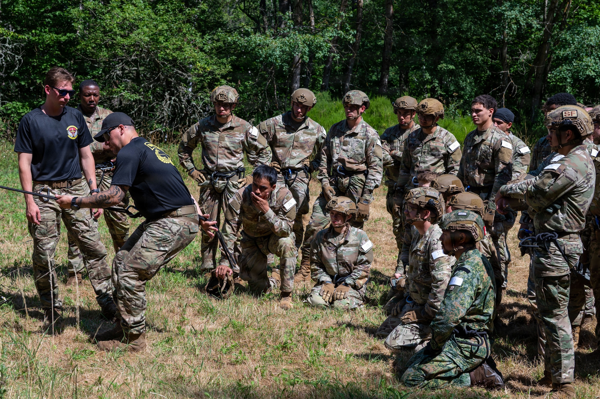 U.S. Air Force Tech. Sgt. Brayan Arroyo and Staff Sgt. Joshua Quaglio, 435 Security Forces Squadron Air Assault Assessment cadres, demonstrate rappelling techniques to candidates during the 435th Security Forces Squadron Air Assault assessment at U.S. Army Garrison Baumholder, Germany, July 9, 2026.
