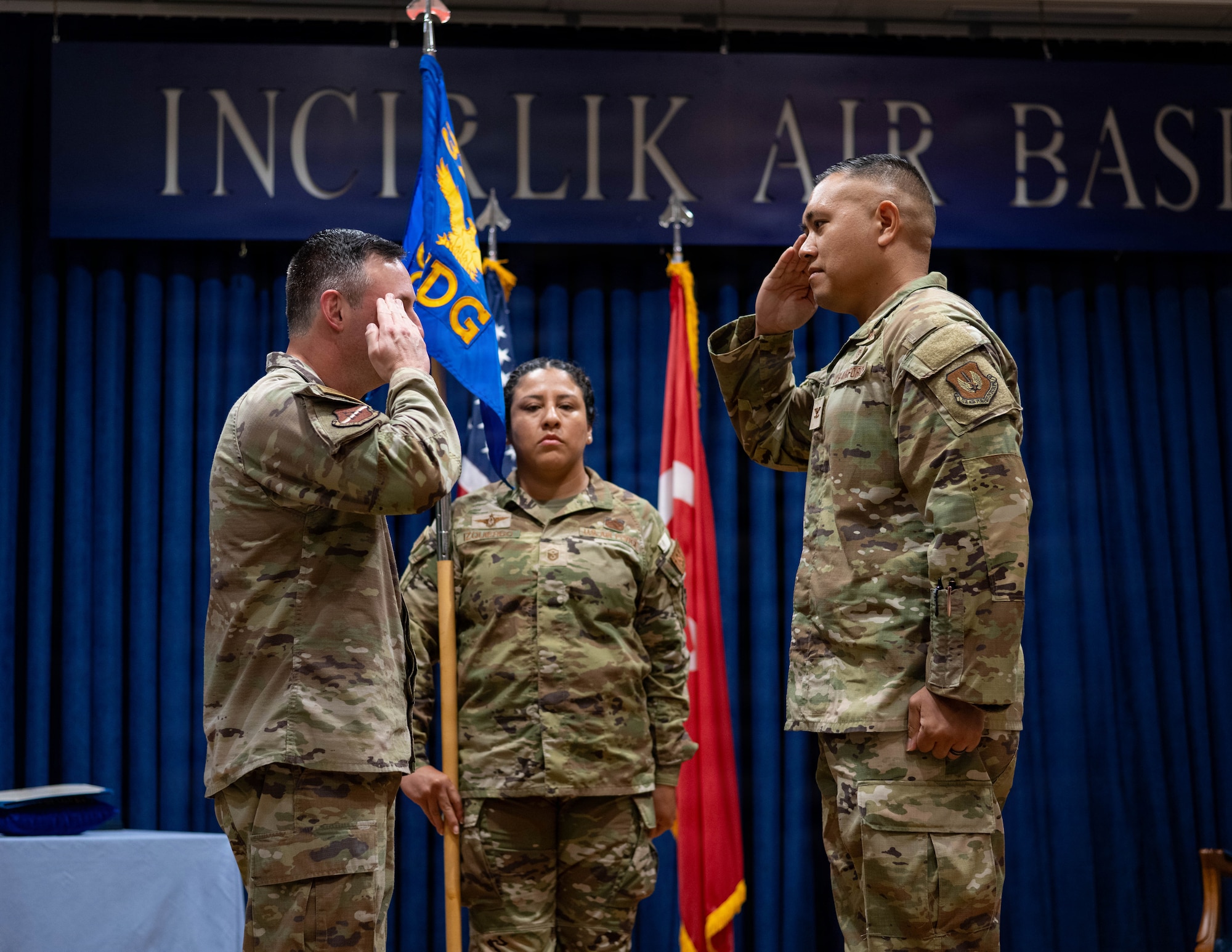 U.S. Air Force Col. Isaac Adams, 39th Air Base Wing commander, salutes Col. David Dy, 39th Medical Group incoming commander,