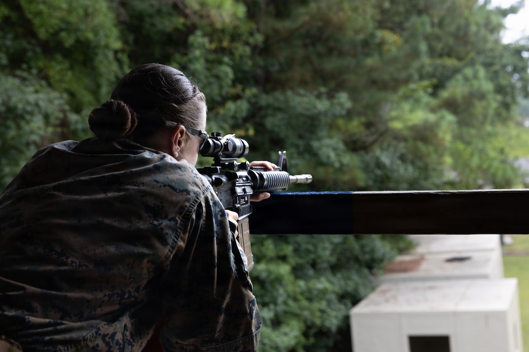 U.S. Marine Corps 1st Lt. Jacie Harlow, a manpower officer with Headquarters Company, 2nd Intelligence Battalion, II Marine Expeditionary Force, aims her M16A4 Service Rifle during a shooting competition on Marine Corps Base Camp Lejeune, North Carolina, July 14, 2026. The multi-stage competition was designed to evaluate shooters on speed, accuracy, and decision-making while moving through dynamic environments. (U.S. Marine Corps photo by Lance Cpl. Dorian Melrath)