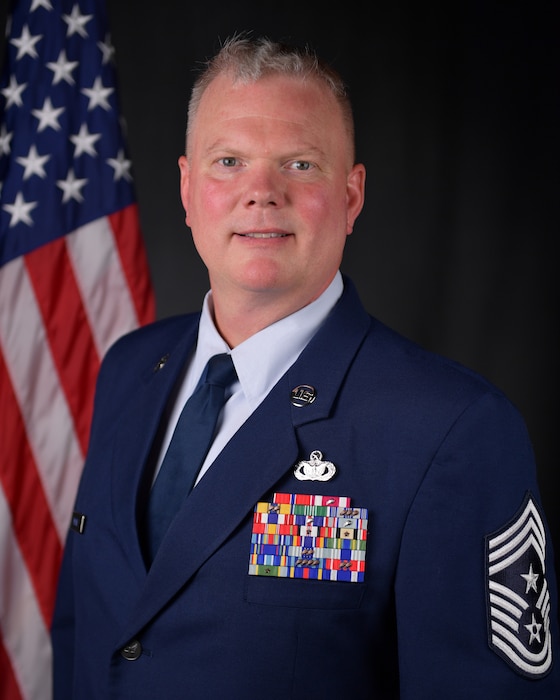 Man in uniform posing for photo.