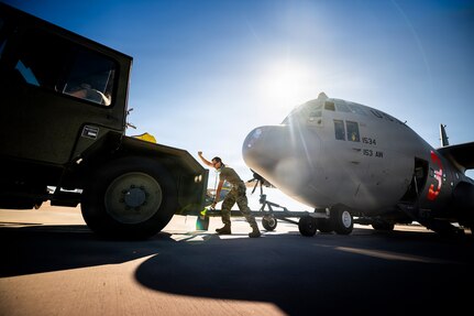 U.S. Air Force Master Sgt. Nathaniel Sobieski, a crew chief assigned to the 153rd Airlift Wing, Wyoming Air National Guard, adjusts tow equipment on a C-130 Hercules aircraft at Cheyenne Air National Guard Base, Wyoming, July 14, 2026.