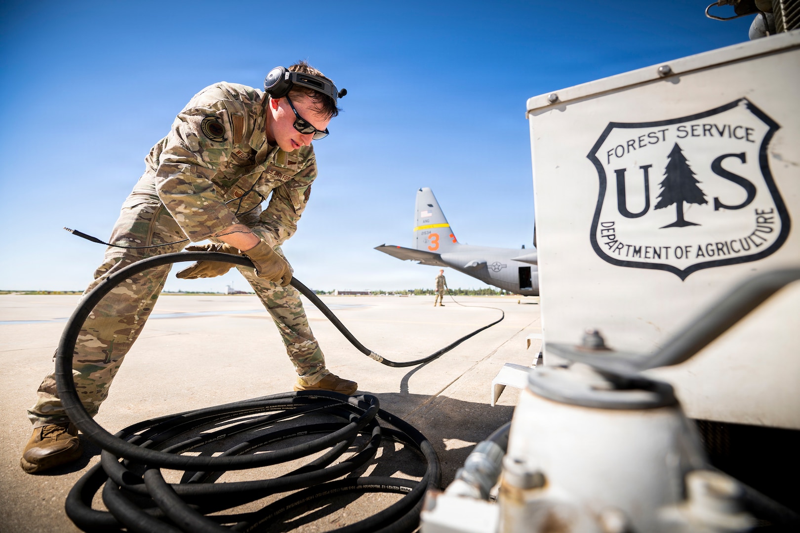 U.S. Air Force Master Sgt. Timothy Williams, a loadmaster assigned to the 187th Airlift Squadron, Wyoming Air National Guard, prepares cable equipment from the U.S. Forest Service power system ahead of functional testing of MAFFS 3, a Modular Airborne Firefighting System, at Cheyenne Air National Guard Base, Wyoming, July 14, 2026.