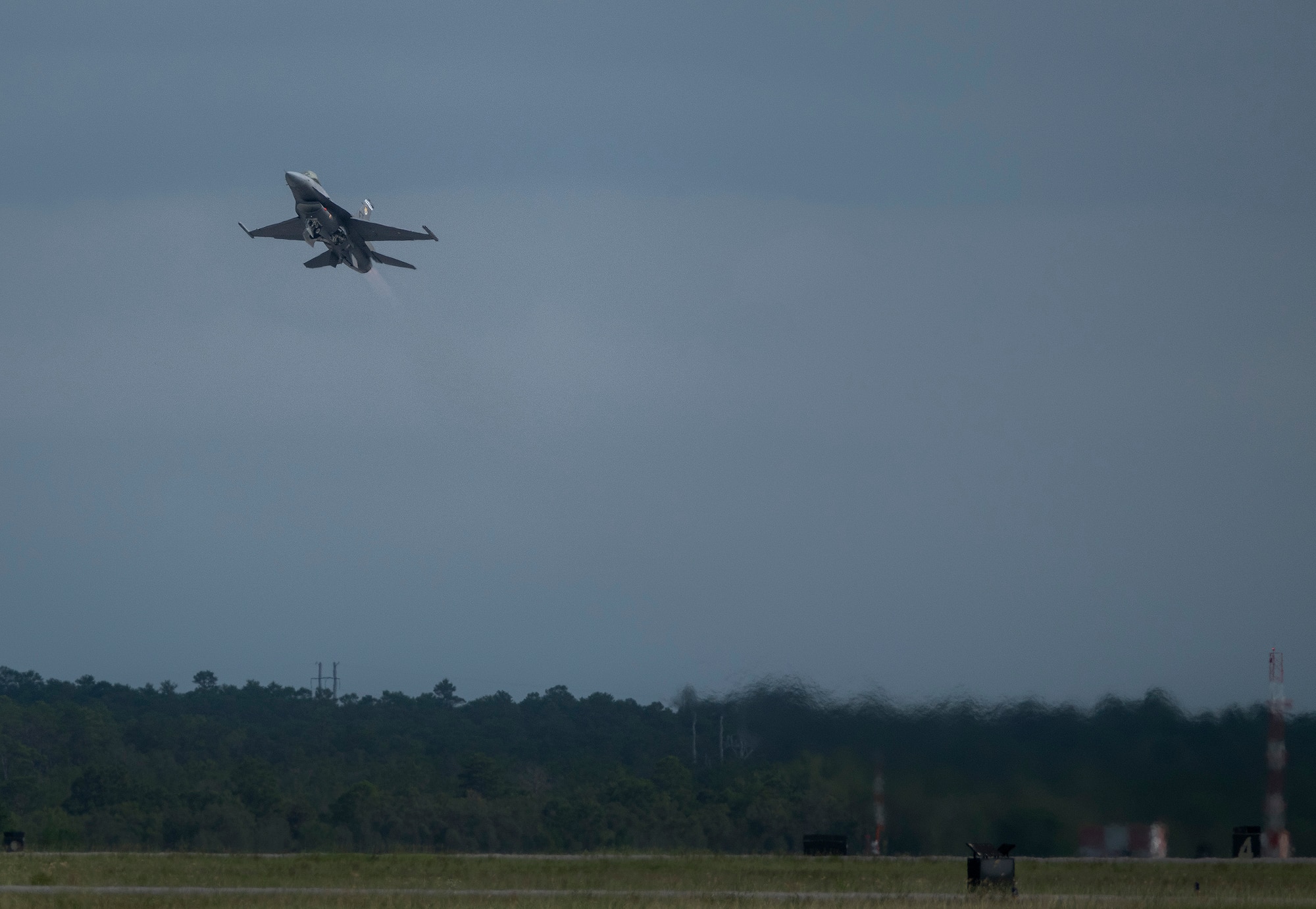 An F-16 Fighting Falcon modified for the Viper Experimentation and Next-gen Operations Model – Autonomy Flying Testbed (VENOM) program conducts flight operations during autonomous systems testing.