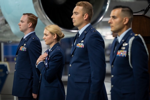 Group of Air Force officers stand in line, wearing dress blues.