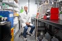 Matthew Yates, Ph.D., U.S. Naval Research Laboratory (NRL) research scientist, poses for a photo in the mobile biomanufacturing system in Washington, D.C., June 23, 2026. Scientists at NRL use the mobile system to develop, prototype, and test technologies for the manufacturing of Department of War-critical materials when and where they are needed. (U.S. Navy photo by Sarah Peterson)