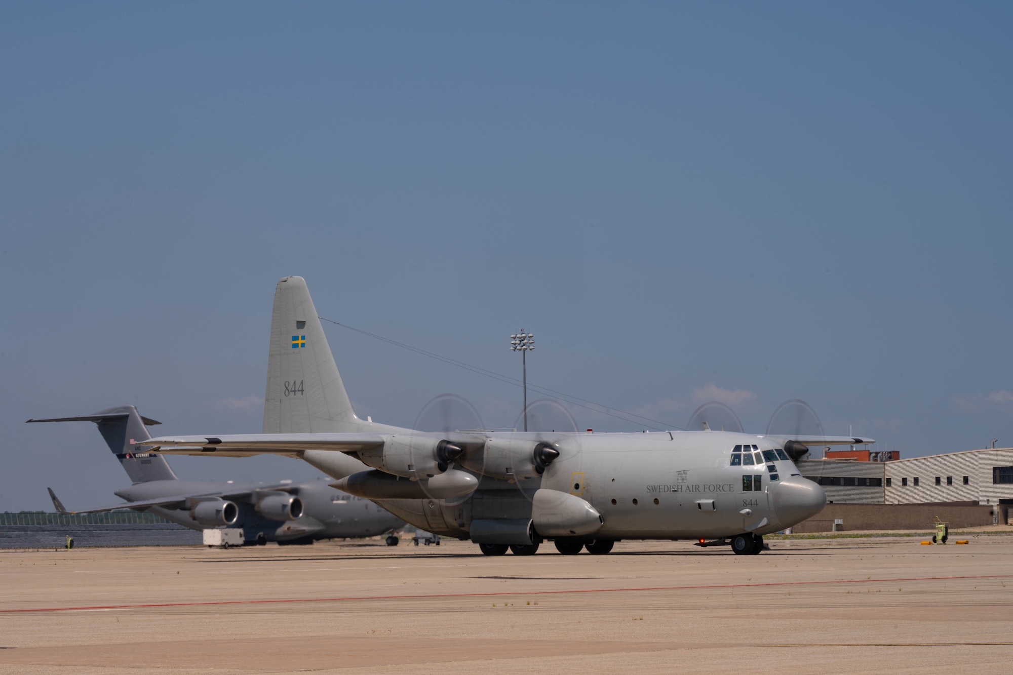 A C-130 Hercules from the Swedish Air Force taxis onto the flightline.