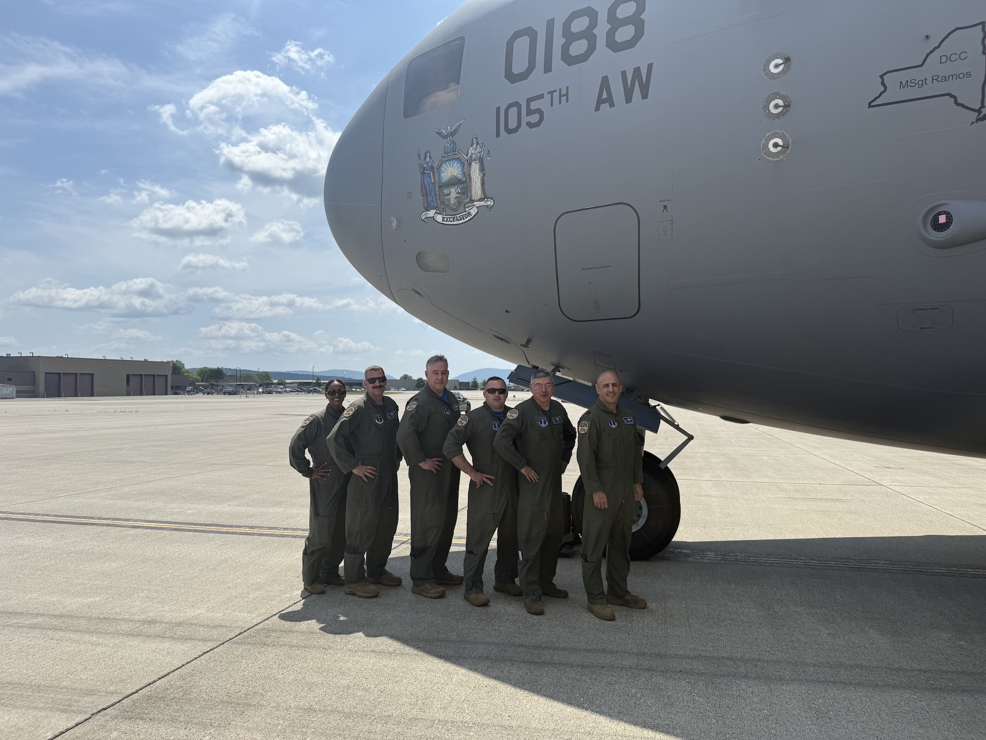 Aircrew pose for a photo in front of a C-17