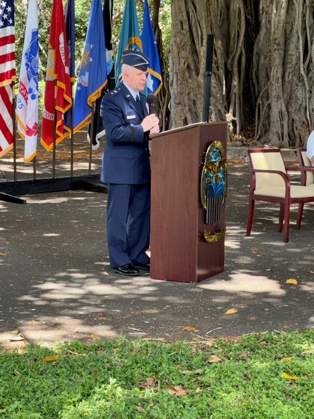 An Air Force major general speaks at a podium.