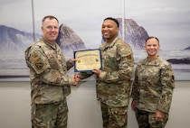Group of people posing with certificate