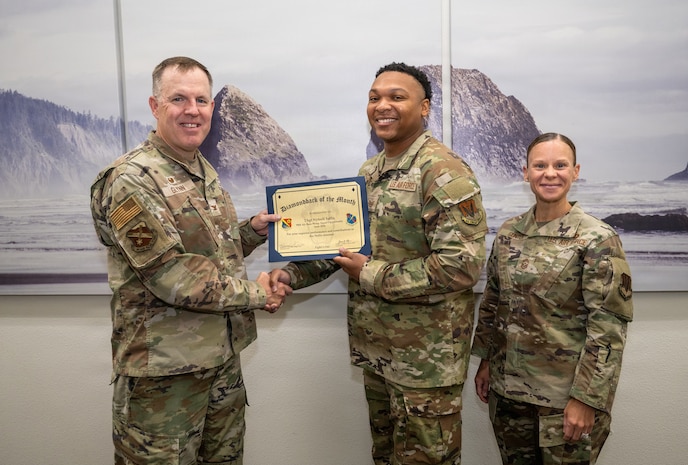 Group of people posing with certificate