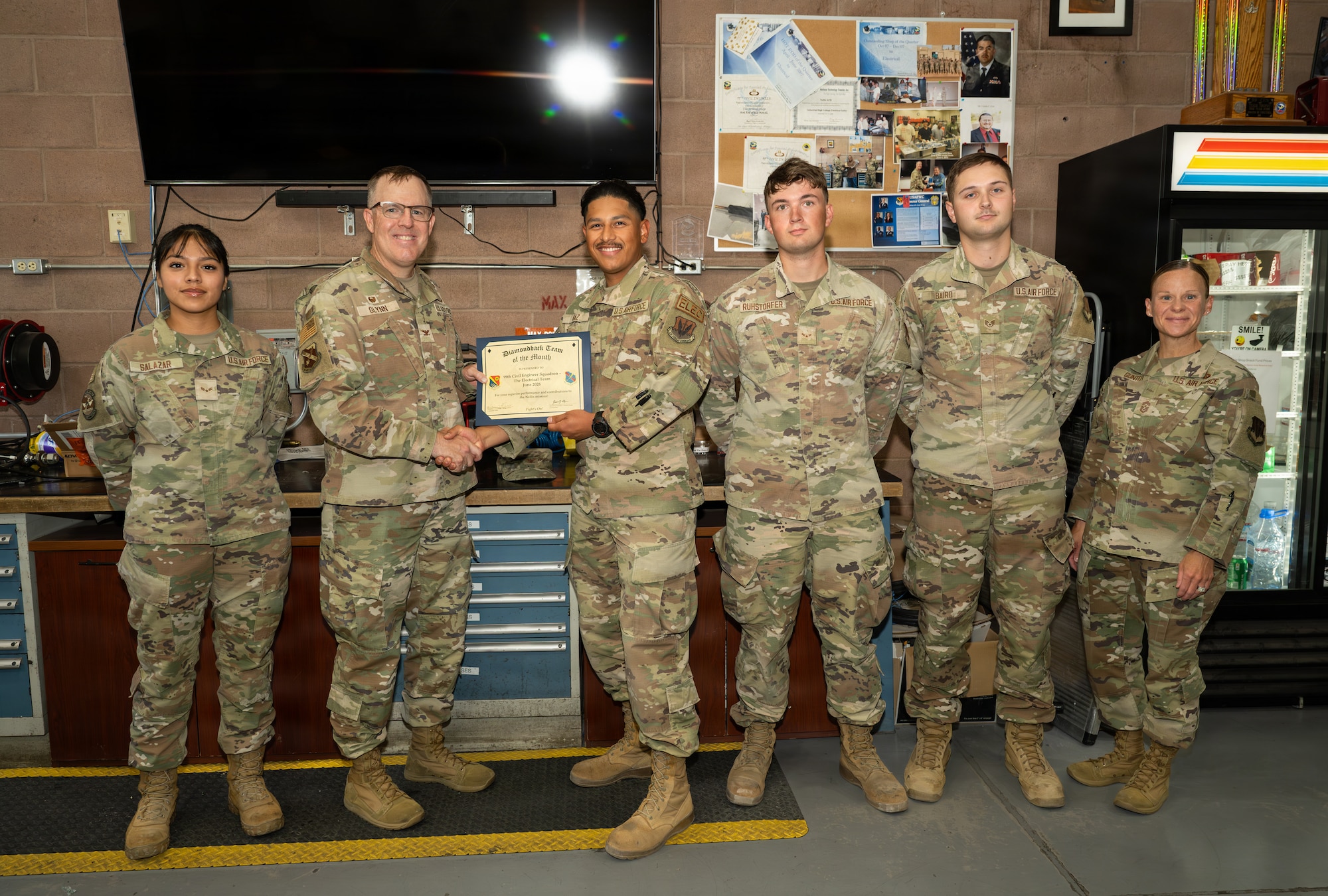 Group of people posing with certificate